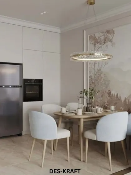 An open-plan space where the dining area, featuring pastel blue chairs and a nature-themed mural, is adjacent to a sleek, modern kitchen.