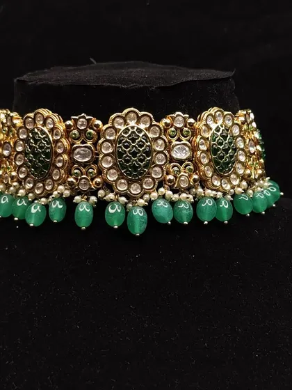 A classic Kundan choker with green enamel work.