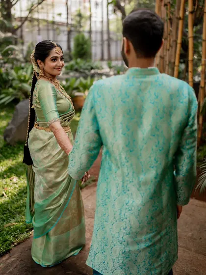 A tender moment between the couple, showcasing their beautiful coordinated outfits. Our goal is to capture the subtle emotions and details that make your wedding portraits special.