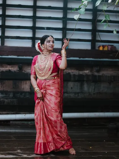 A beautiful portrait of the bride touching a leaf, her expression serene.