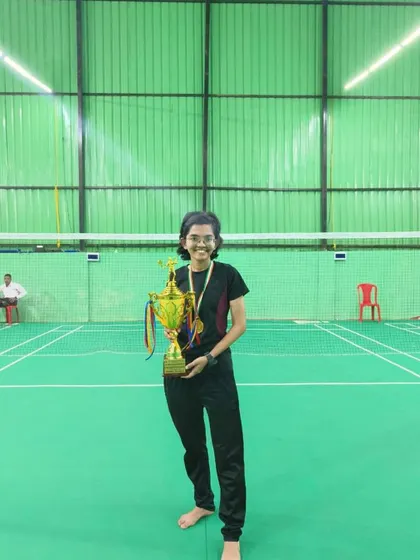 Our women's team event winner from the Mumbai University inter-collegiate tournament, showcasing her championship trophy.