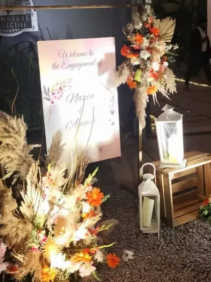 A close-up of the welcome area for the engagement, highlighting the mix of dried pampas, fresh florals, and wooden crates for a textured, rustic look.