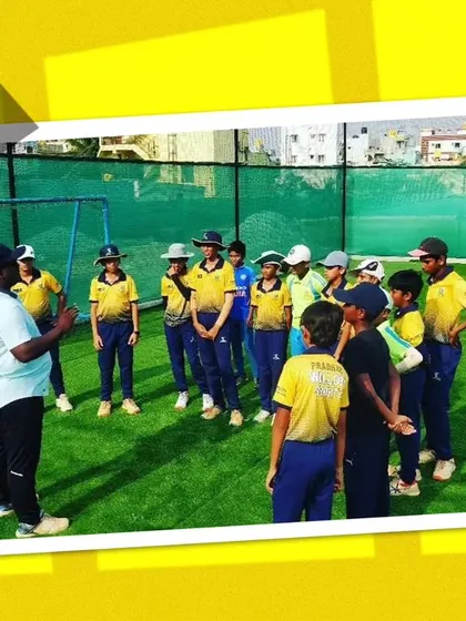 A coach addressing a group of young players. Clear communication and instruction are key to our coaching method.