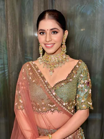 Radiating elegance and charm for her reception. This look combines traditional grace with modern glam, featuring a flawless base and beautifully defined eyes.