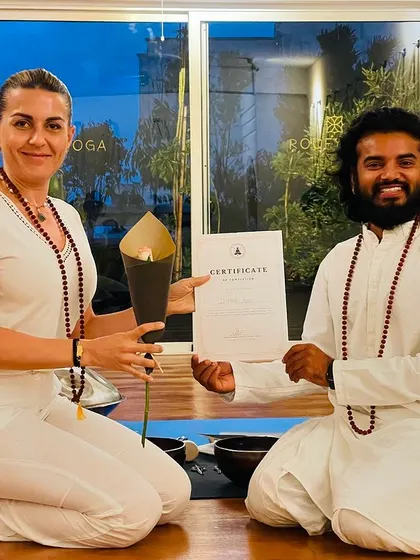 A student receives her certificate and a lotus flower, a symbol of purity and enlightenment, at our Casablanca training.