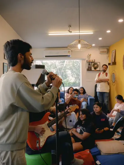 A student sharing his music during an open mic session. Our space is always open for students to practice performing in a low-pressure, supportive environment.