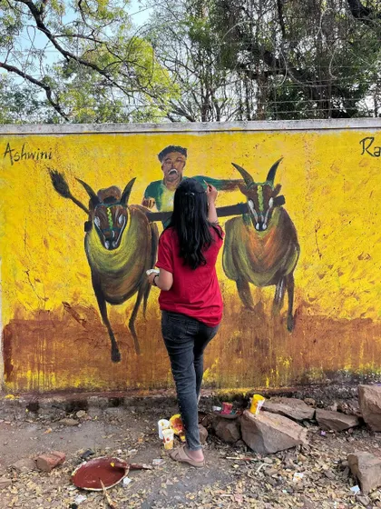 Here you can see me adding details to the bull race mural. I start with a rough sketch and build up layers of acrylic paint to create depth and movement, a process that truly teaches you to trust the outcome.