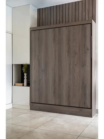 This is another example of a Murphy bed, shown here in its folded position. It looks like a simple, modern wooden wardrobe, completely hiding the bed and allowing the room to be used for other purposes.