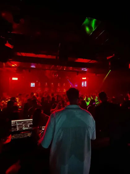 Overlooking a packed dance floor from the DJ booth. This is my office, and my job is to make sure the energy never dips.