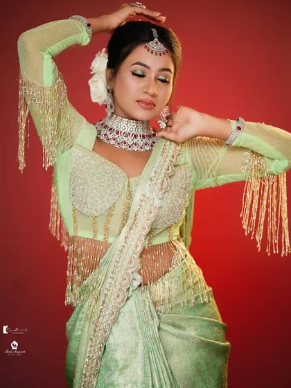 This pose shows the full effect of the fringed blouse and the elegant makeup.