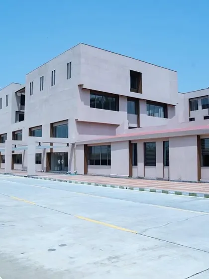 A wide shot of the Konark Academy building, emphasizing its linear design and the rhythmic placement of windows. The architecture is clean, modern, and functional, designed to house a dynamic learning community.