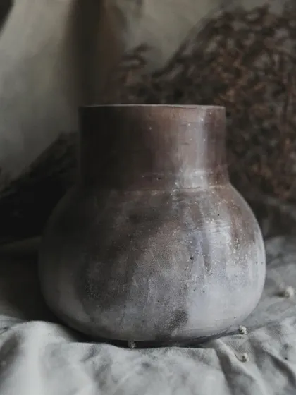 I call this pit-fired vase 'Stardust'. I achieved this subtle, speckled effect by throwing sawdust onto the piece when it was still hot from the fire. It’s a beautiful, earthy piece for dry arrangements.
