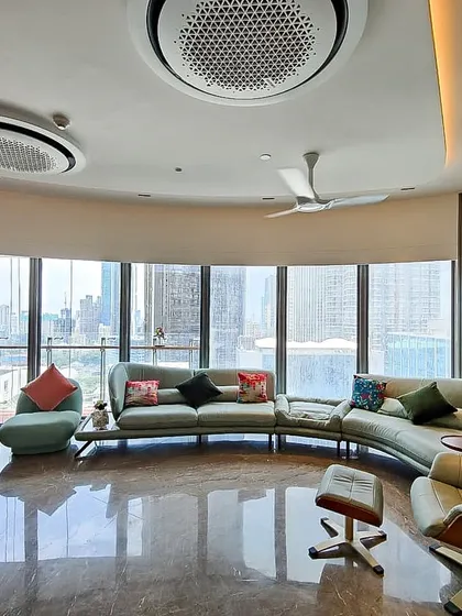Another angle of the Jesrani Residence living room, highlighting the custom wall niches and the gentle curve of the space. The design ensures that every part of the room benefits from the incredible view and abundant daylight.