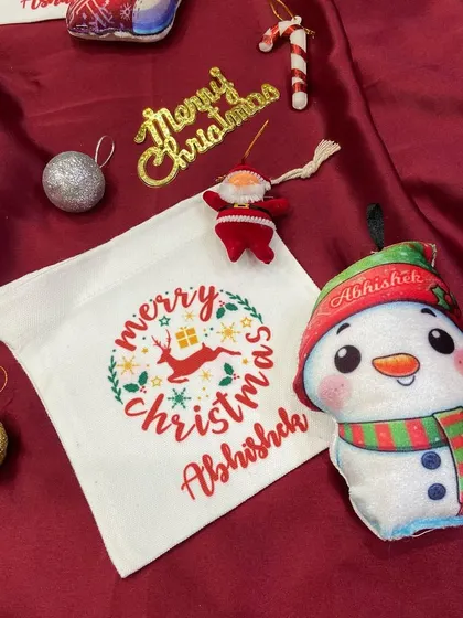 This personalised snowman plush ornament comes with a matching Christmas goodie bag, making it a complete and adorable gift.