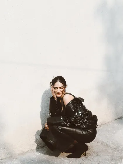 A candid, happy moment with Kavya Trehan in a leather outfit. The contrast between the tough material and her soft smile is what makes this shot special.