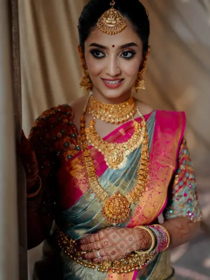 A close-up of this beautiful bride, ready for her Muhurtham. The makeup is kept classic and radiant to complement her traditional gold jewellery.