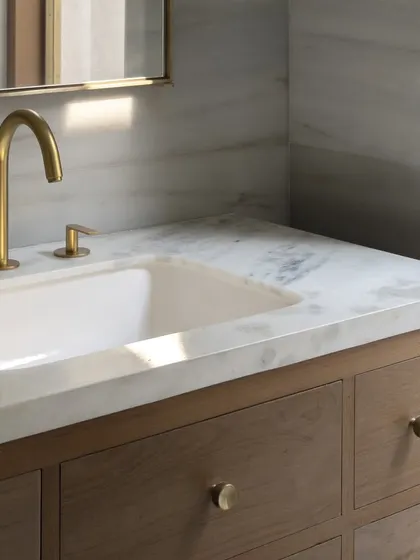 Even the smallest elements are an opportunity for thoughtful design. These custom brass knobs, seen here on a bathroom vanity, carry the material language of brass and wood into every corner of the DUA Villa.