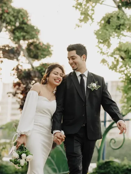 An elopement is a profoundly personal affair, and I aim to capture that intimacy. Here, Charlene and Dexter share a happy, relaxed moment after their ceremony in Dubai, their joy lighting up the beautiful garden setting.