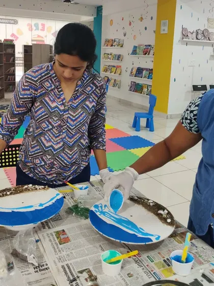 Two women collaborating and learning the fluid art of resin pouring during one of our weekend workshops.