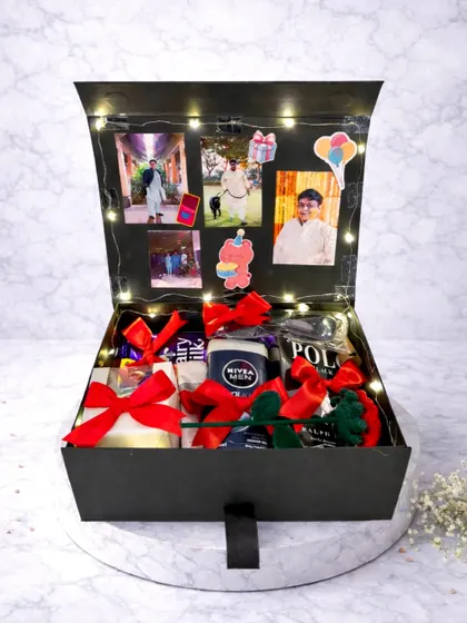 This birthday box for him is all about personalization. The lid opens to display a collection of his favorite photos, lit up with fairy lights, while the box itself is filled with grooming products and chocolates.