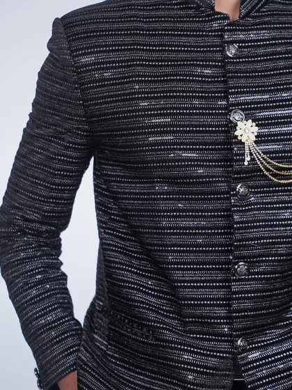 A close-up of the brooch detail on the black sequined bandhgala. It's the perfect finishing touch.