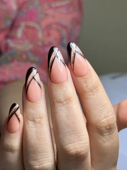 A close-up of the modern black and glitter French design, showing the clean lines and flawless application.