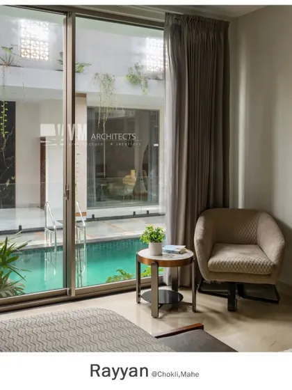 In the Rayyan project, the bedroom offers a tranquil view of the indoor swimming pool through large glass sliders, creating a resort-like feeling of relaxation.