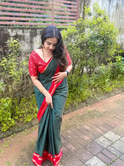 A full-length view of this understated and elegant look. The hair is styled in simple, loose waves, and the makeup is fresh and light, perfect for a daytime family gathering.