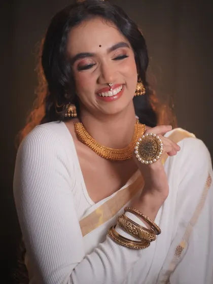 A joyful shot of the model, her smile lighting up the frame. This look is all about celebrating natural beauty with a festive touch.