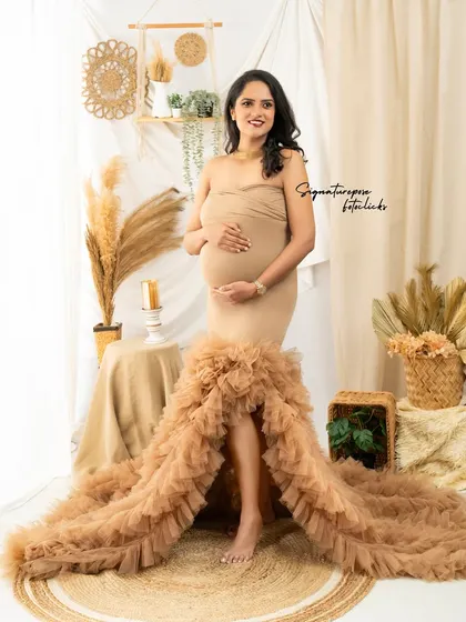 This shot captures the elegance of the gown and the warm, inviting atmosphere of the boho-chic setup.
