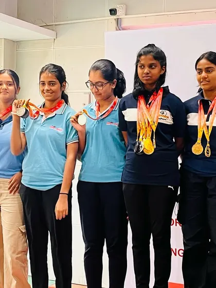 A group of our decorated women's pistol shooters on the podium.