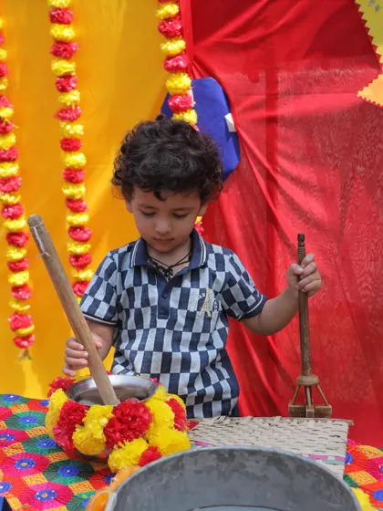 A young boy explores a traditional butter churner (madhani) during our Baisakhi event. We believe in learning about culture through interactive and tactile experiences.