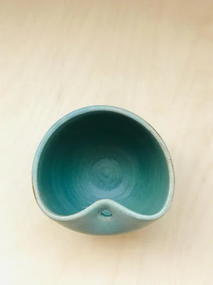 The "Sipura" cup from above, showing its smooth, matte teal interior and the thoughtfully designed spout.