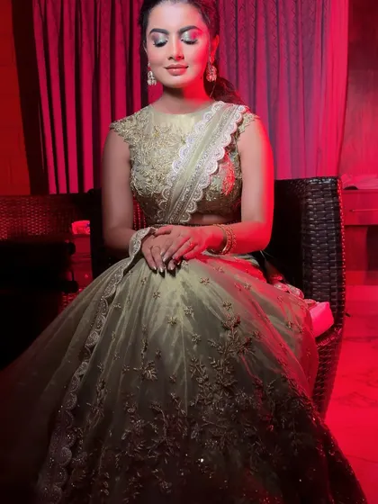 A dramatic shot of the client, showcasing her full lehenga and the subtle sparkle of her jewellery.