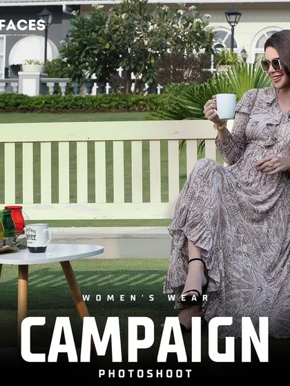A lifestyle campaign shot of a model in a long printed dress, relaxing on a park bench with a cup of coffee.