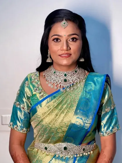 Our happy bride Deekshita chose this elegant American diamond and emerald choker set with a matching vaddanam for her big day.
