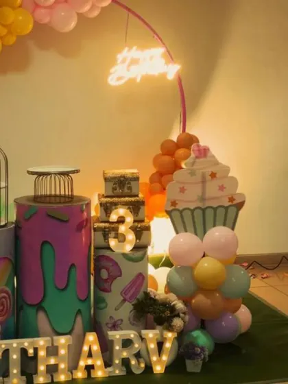 A close-up of the props from the candy-themed party, including the light-up number '3' and custom-printed plinths.