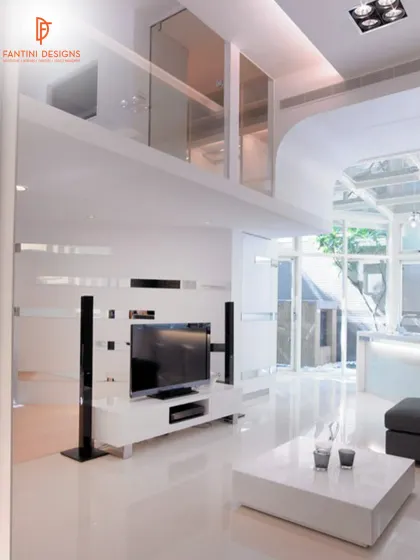 A full view of a sleek, modern living room with a double-height ceiling and glass mezzanine. The white polished floors and minimalist furniture create a very clean and high-end look.
