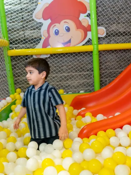 A young explorer navigates the colorful ball pit. Free play in a safe environment like this allows children to build confidence and independence at their own pace.