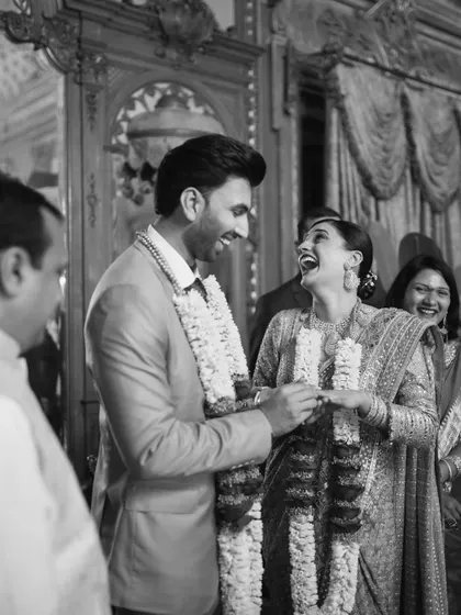A black and white photo of the couple laughing during their ring exchange. This timeless image perfectly captures the happiness of the moment.
