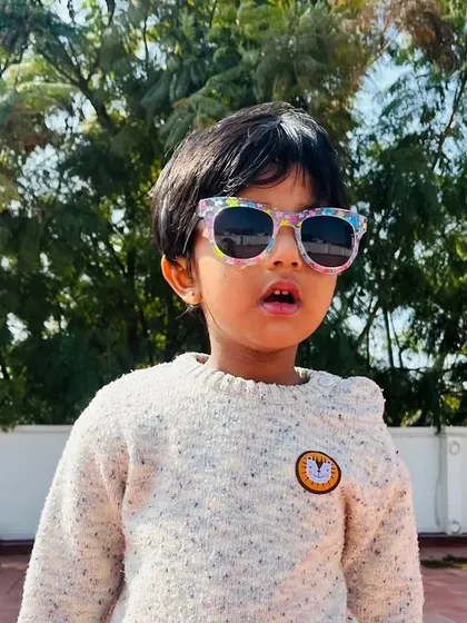 Another stylish student enjoying the sunny day outdoors, learning about the seasons through direct experience.