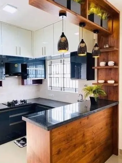 This kitchen features a peninsula that separates the cooking area from the living space while providing a cozy breakfast counter. The design combines wood and black gloss for a modern look.