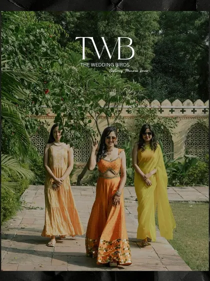 The bride and her bridesmaids posing in a beautiful garden during the haldi ceremony. Dressed in shades of yellow and orange, they look like a ray of sunshine.
