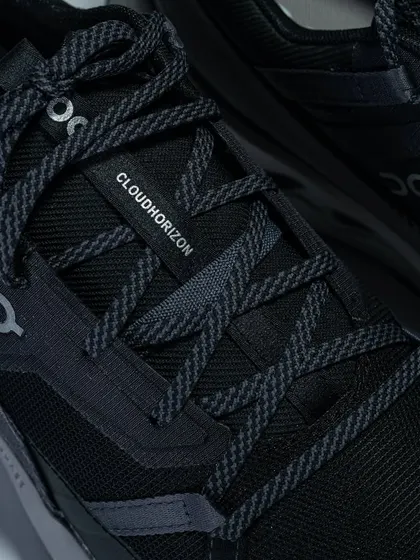 A close-up of the lacing system and 'Cloudhorizon' branding on the On Running shoe.