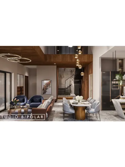 In this 5000 sqft villa in Gandhidham, we designed an open-concept living and dining area to be the heart of the home. A double-height ceiling over the dining area connects the space to the upper floors.
