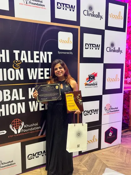 A jury member poses with her award, certificate, and a sponsored goodie bag. This shows how we integrate our sponsors' branding into every aspect of the event, from the stage to the gifts.