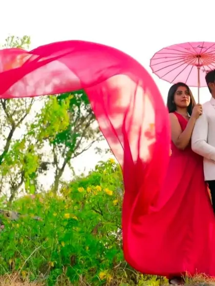 A creative use of our red flying dress, with the trail flowing in the wind while the couple poses with an umbrella.