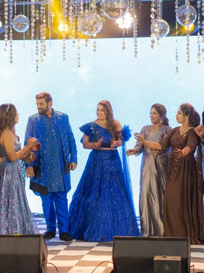 Family and friends join the couple on stage for a fun dance number. The sangeet is all about participation, and I ensure there's plenty of space for everyone to join in the fun.
