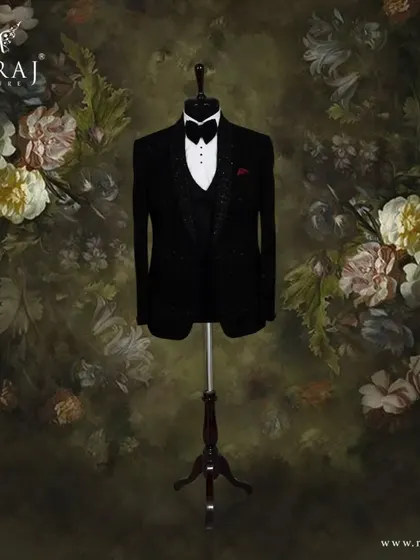 A classic black velvet tuxedo for the discerning groom. This piece is crafted with self-embossed designs and delicate hand embellishments for a bold statement.