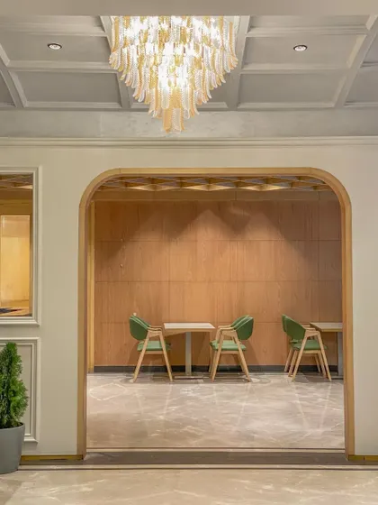 Framed views are a key design tool. Here in the Bhopal lobby, an arched opening perfectly frames a quiet seating area, creating a sense of depth and architectural interest.